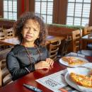 Taking a break from saving the city, Tristan McLean grabs a slice after trick-or-treating. 