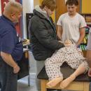 The students check the dummy for injuries.