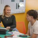 Gloria Jorjakis and Frederic Roy take notes.