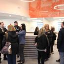 Many mingle before the ceremony with the mural behind them.