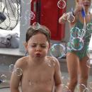 Lincoln, 5, tries his best to blow the bubbles around. 