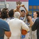 The team cheers on as they raise their trophy high. 