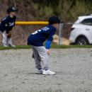 Players on the Farm division wait for the pitch. 