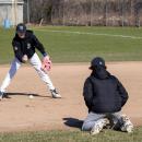 The players focus on catching the ball low.