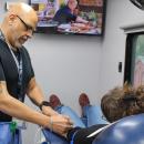 Martinez marks a donor's arm for optimal needle placement. 