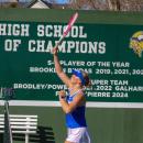A Wareham player stretches to hit an overhead ball. 