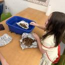 Students work at making aluminum foil boats. Photos source: Elizabeth Costa