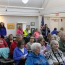 The crowd listens to speakers.