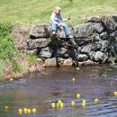 A spectator watches the ducks round the curve.