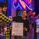 Owner Phill Warren accepts a citation from Kelly Dooner's office. 