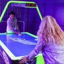 LJ Burdette and Terisa Bumpus dueling in air hockey.