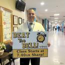 Wareham High School Principal Scott Palladino holds a sign reminding students to get to class before the morning bell. Photo by Grace Roche