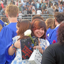 A graduate hugs their friend. 