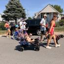 residents walk down the road for the parade
