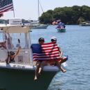 Two hold flag at front of boat