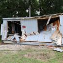 The front of a utility shed behind the 7-Eleven was caved in after a car slammed into it early morning on Monday, Aug. 3. Photos by Nick Mossman