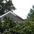 An edge of the garage roof was sliced open, but much of the garage remained unharmed.
