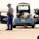 Police searching the vehicle at Swifts beach. Photos by David Curran