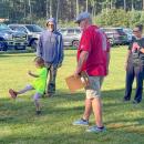 A Youth Soccer player hits a shot while Elks volunteers watch on. Photos by Jim Callan