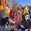 Costumed children take candy from a sombrero-shaped dish outside El Mariachi. 