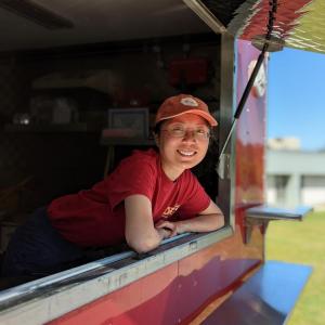 Lee leans outside her food truck.
