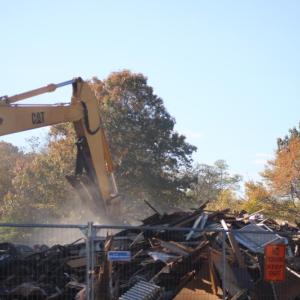 Dust settles as the home is leveled. Photo by Brandy Muz