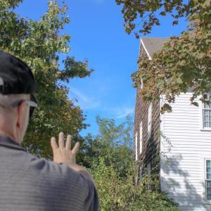Carlston Wood stands outside of the famously haunted Fearing Tavern. Photo by Brandy Muz