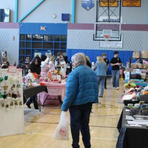 The gym packed with booths and tables.