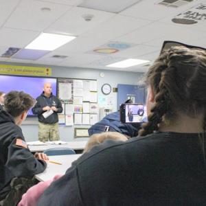Ava's mother Jenna snaps photos of the ceremony.