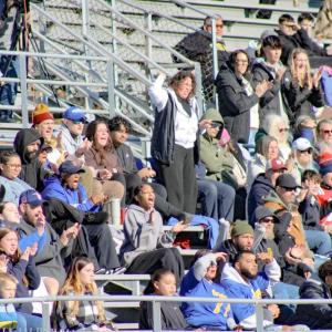 Fans hoot and holler for a touchdown.