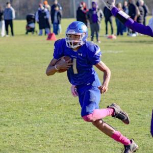 Amare Rose runs for the endzone, avoiding a tackle.