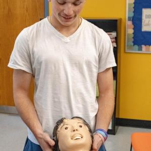 Frederic Roy makes sure the dummy's airway is clear.