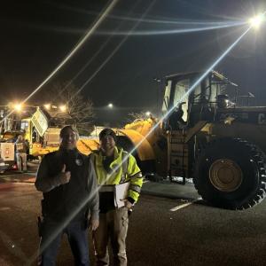 David Menard and Calib LaRue next to front-end loaders.