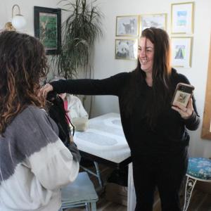 Andrea Ericson handing out bags with art supplies to students.