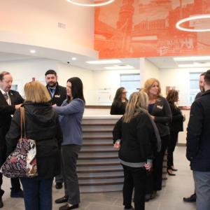 Many mingle before the ceremony with the mural behind them.