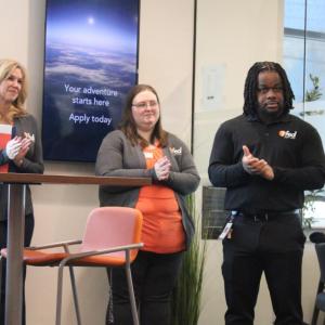 Bank members clap following the cutting.