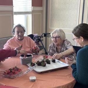 Students work to decorate the strawberries with residents. Photos source: Wareham High School
