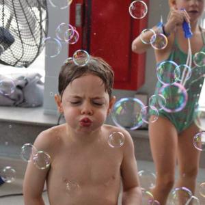 Lincoln, 5, tries his best to blow the bubbles around. 