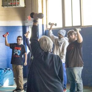 Marybeth Kiernan helping her students with proper form.