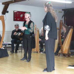 Regina Delaney, left, sings an Irish folk song backed by harps inside Redmen Hall on Sunday, March 29. Photos by Grace Roche
