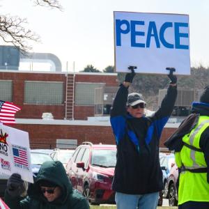 One protestor simply asks for peace. 