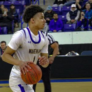 Aaron Cote makes a move toward the basket.