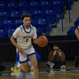 Moving fast, Amare Rose makes his way to the net.
