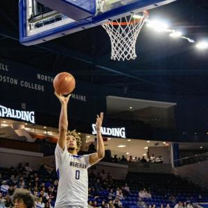 A rebound shot sees Amare Rose get air.