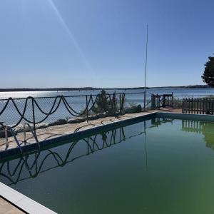  In the coastal enclave of Dolphin's Cove, 22 Spindrift Lane offers a truly rare waterfront setting defined by unobstructed views and a private stretch of beach - an increasingly scarce combination on Cape Cod. 