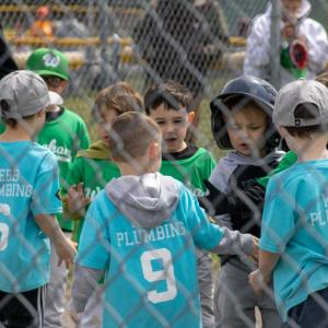 Two teeball teams showing good sportsmanship following their game.