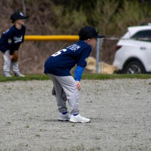 Players on the Farm division wait for the pitch. 