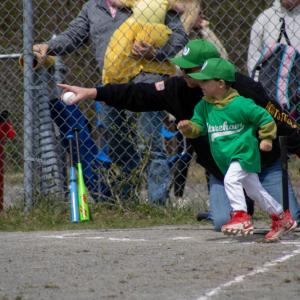 A player on the Dance Innovations VIP Teeball team bolts for first plate. Photos by Brandy Muz