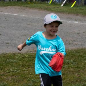 A Webb Plumbing player goes for the ball in the out field. 
