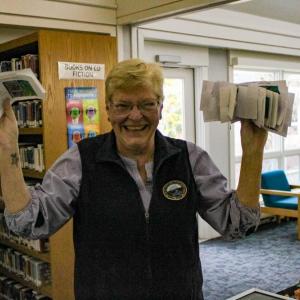 Town Clerk Lisa Johnson holding up the 'real' voting ballots for the town peep election. 